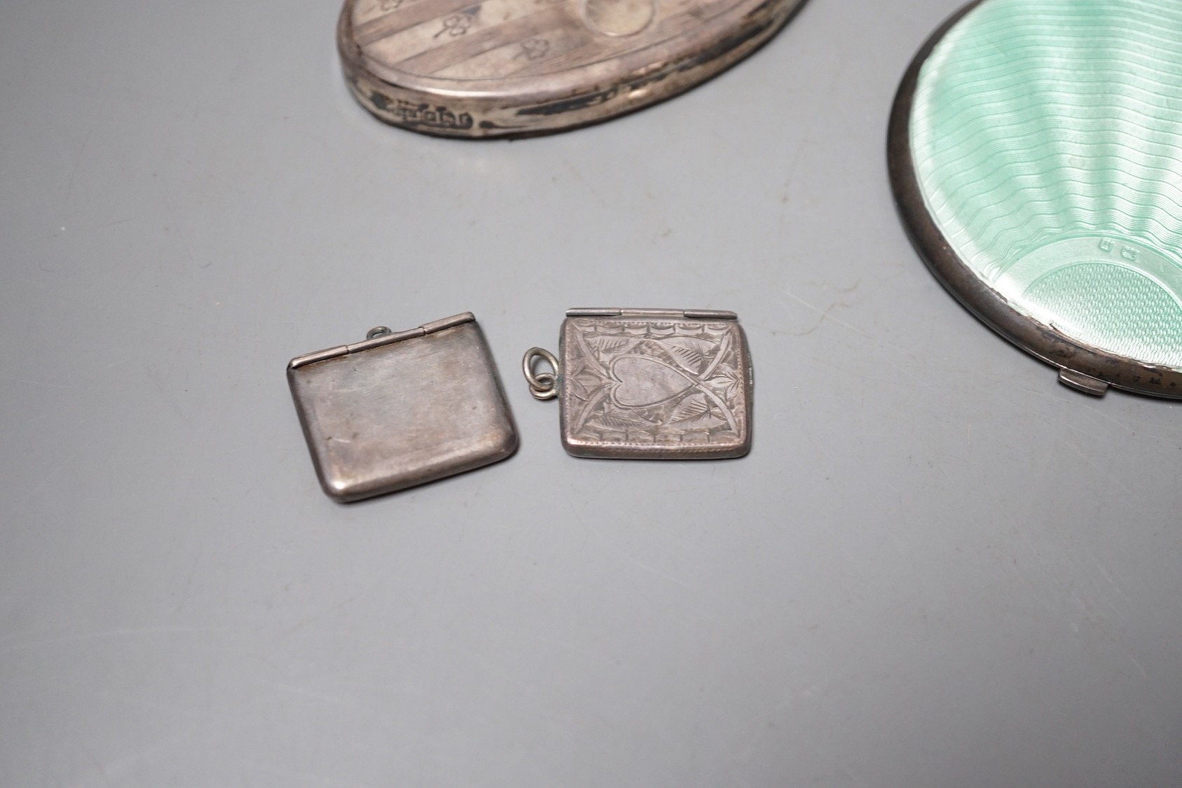 A 1930' silver and green enamel mounted compact, a silver mounted ring tree and two early 20th century silver 'envelope' stamp cases, one with enamel.